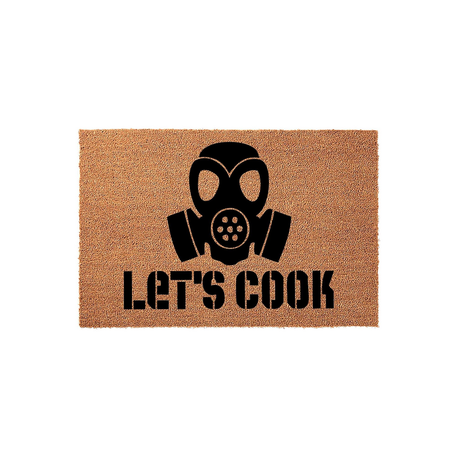 Let's Cook gas mask doormat featuring a bold black graphic of a respirator mask printed on a natural tan coir fiber mat, creating a fun and unique entryway decor piece for fans of iconic television crime dramas and cooking themes.