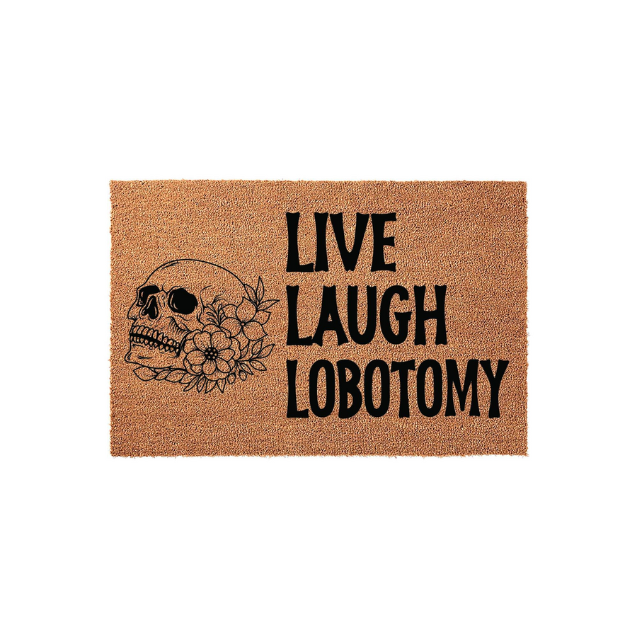 Live Laugh Lobotomy funny doormat featuring a black printed skull surrounded by floral accents on a natural coir fiber background, creating a dark humor aesthetic for a unique entryway or porch decor piece that stands out to