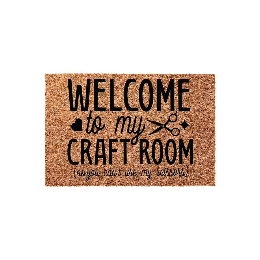 Craft Room Welcome Doormat featuring a natural coir texture with bold black text that reads Welcome to my Craft Room, no you can't use my scissors, accented by a heart and scissor icon on a clean white studio background.