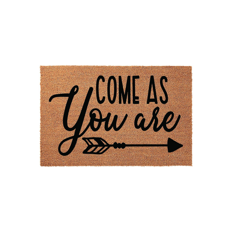 Come As You Are coir doormat featuring a natural brown fiber texture with black printed text and a decorative arrow graphic, creating a welcoming and rustic entryway decor piece for your front porch or home entrance on a plain
