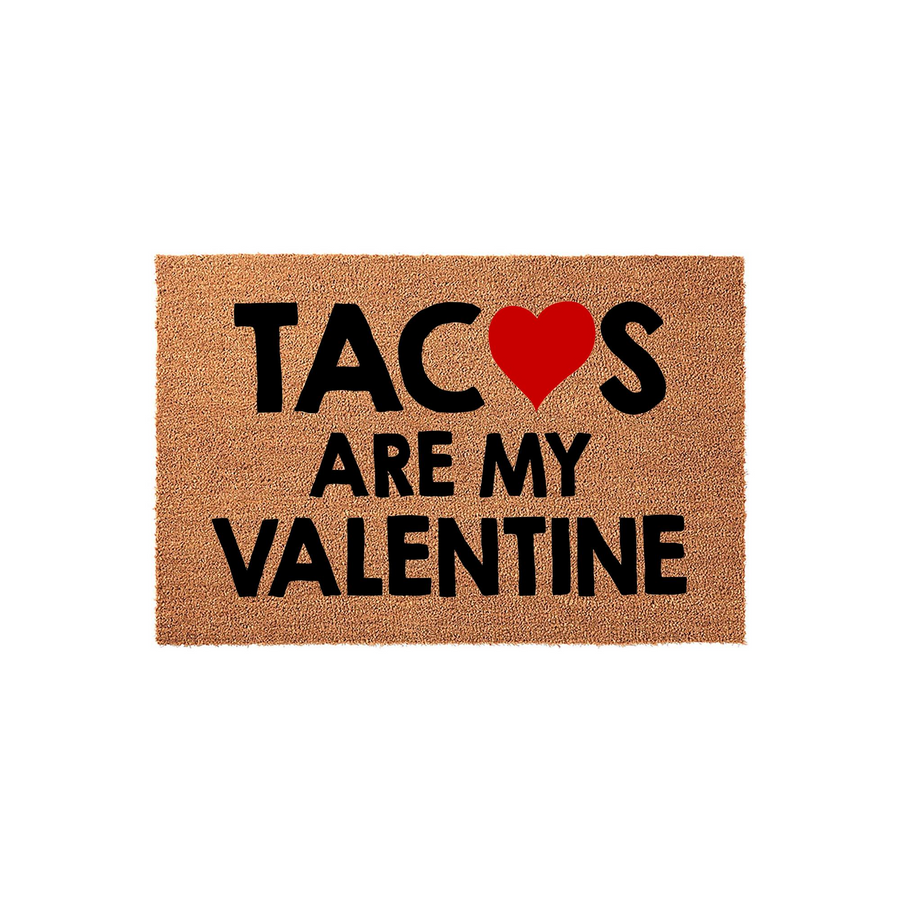 Tacos Are My Valentine coir doormat featuring a natural brown fiber texture with bold black text and a bright red heart icon, making it a fun and festive front porch decor piece for the holiday season on a plain white background.
