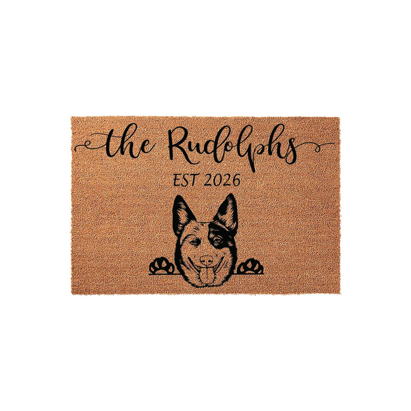 Personalized Blue Heeler dog doormat featuring a natural coir texture, custom family name text in elegant script, and a detailed illustration of a Cattle Dog peeking over the bottom edge for a charming entryway decor accent.