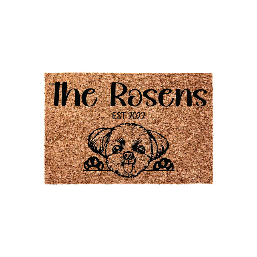 Personalized Shih Tzu dog doormat featuring a cute illustrated puppy peeking over the edge, customized with a family name and established year on a natural coir fiber background for a welcoming front porch entrance decor.