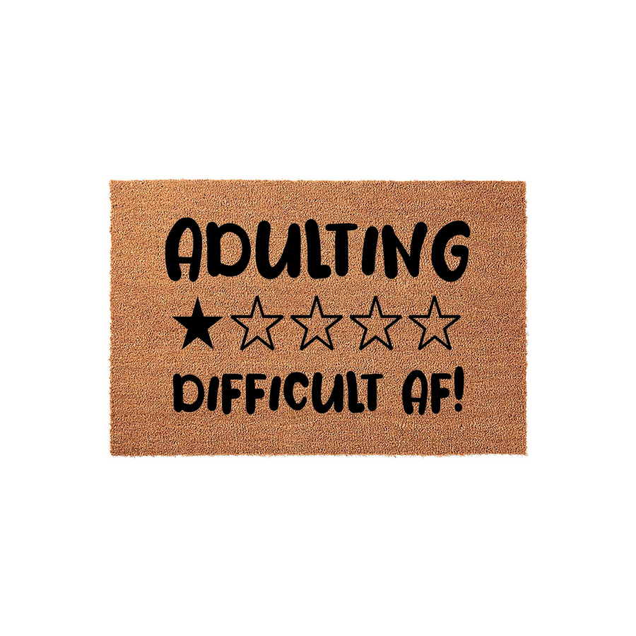Adulting Difficult AF funny coir doormat featuring a one-star rating graphic printed in bold black text on a natural brown coconut fiber mat, creating a humorous welcome mat for a modern home entrance or apartment front door.