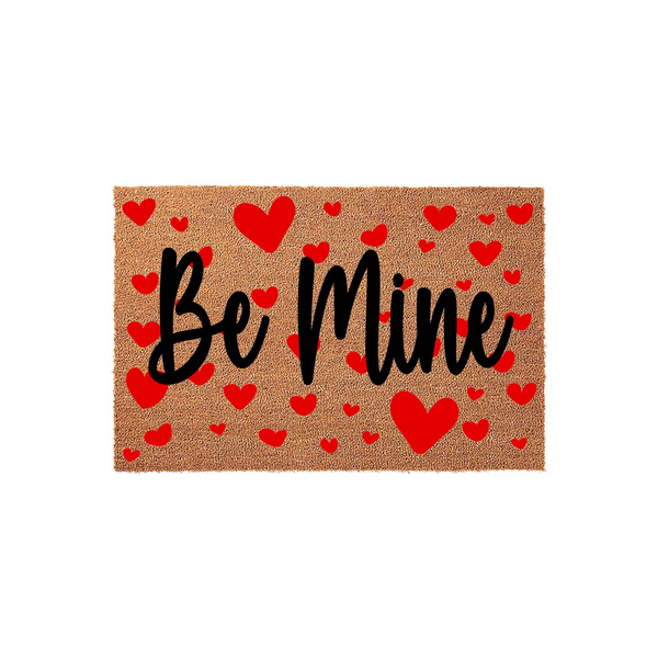 Be Mine Valentine coir doormat featuring a natural tan fiber texture decorated with many small red hearts scattered across the surface, creating a festive and romantic entryway decor piece for the holiday season on a white