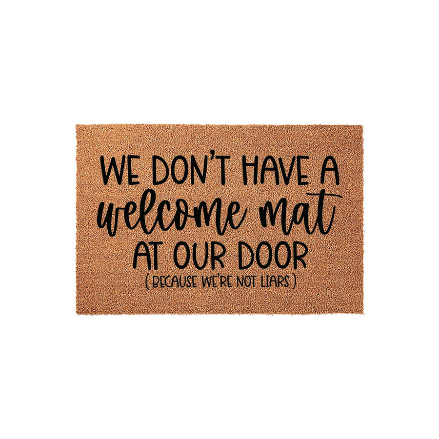 Funny Coir Doormat with the text We Don't Have A Welcome Mat At Our Door Because We're Not Liars printed in black ink, featuring a natural brown fiber texture on a clean white background for a humorous front porch entryway decor.