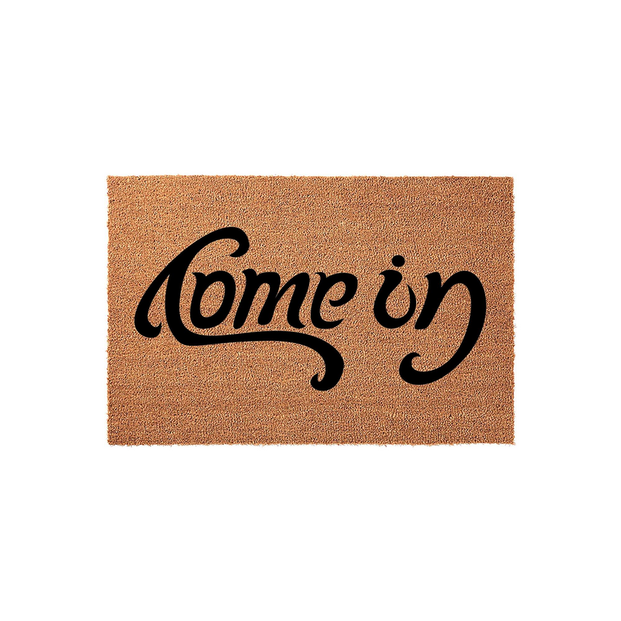 Come In Coir Doormat featuring a natural tan fiber texture and bold black cursive lettering centered on the rectangular mat, providing a welcoming and stylish decorative accent for your front porch or entryway floor decor.