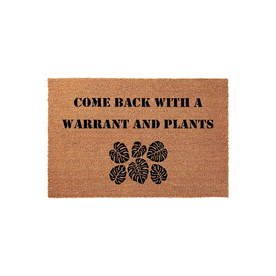 Funny Come Back With A Warrant And Plants Coir Doormat featuring a natural brown fiber texture and bold black text, accented with a cluster of tropical monstera leaf illustrations for a unique and humorous entryway decor