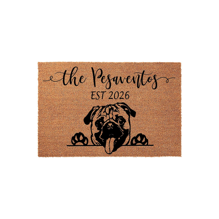 Personalized Pug dog doormat featuring a cute black and tan illustration of a pug peeking over the edge with its tongue out, customized with a family name and established year on a natural coir fiber background for a welcoming