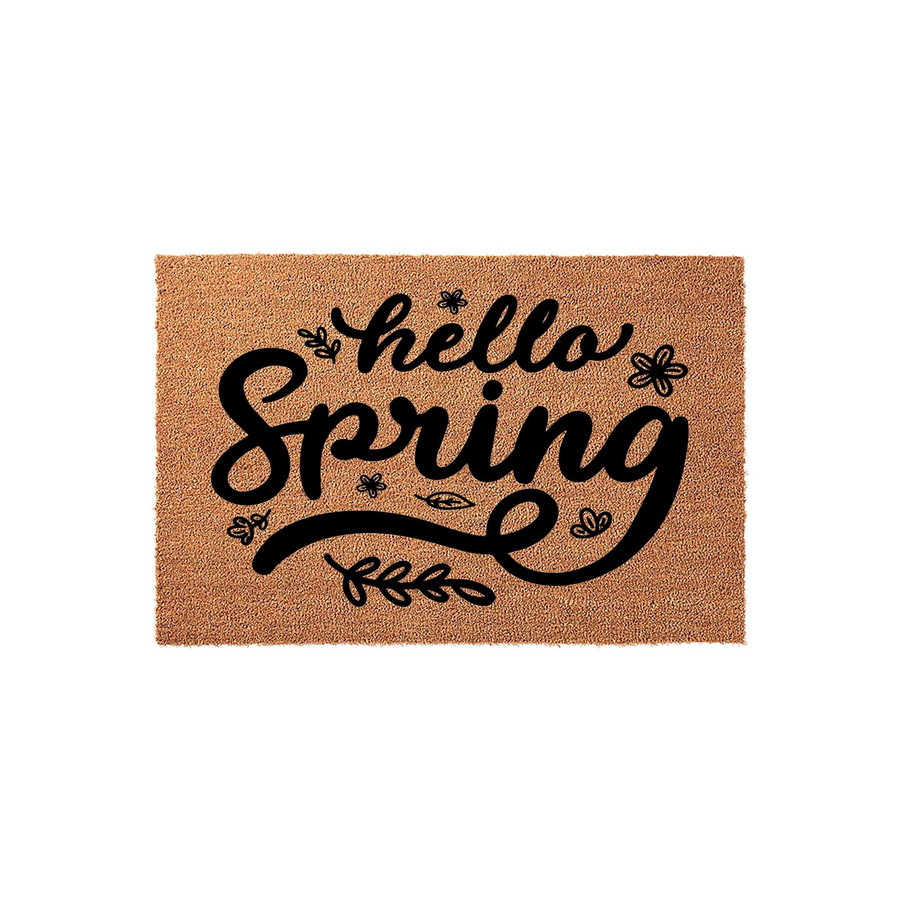 Hello Spring coir doormat featuring a natural tan fiber texture with bold black script lettering and decorative floral accents, providing a welcoming seasonal touch for your front porch entryway decor on a clean white background.