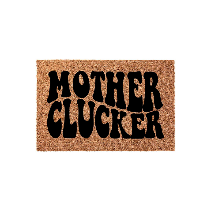 Mother Clucker funny doormat featuring bold black retro-style typography printed on a natural tan coir fiber mat, set against a clean white background for a humorous and welcoming entrance to any home or farmhouse porch area.