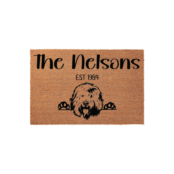 Personalized Doodle Dog Doormat featuring a cute shaggy dog peeking over the bottom edge, printed on a natural coir fiber mat with a custom family name and established year in bold black lettering for a welcoming front porch