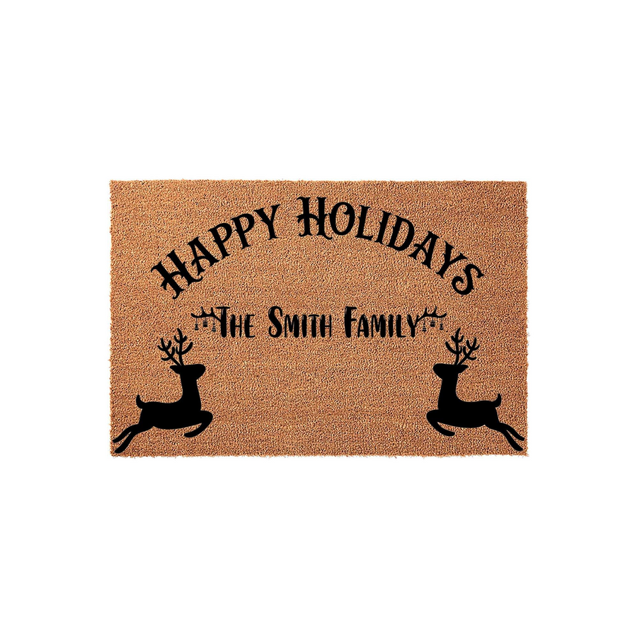 Personalized Happy Holidays coir doormat featuring a festive reindeer design and space for a family name, set against a clean white background to showcase the natural tan texture of the durable outdoor welcome mat for the winter
