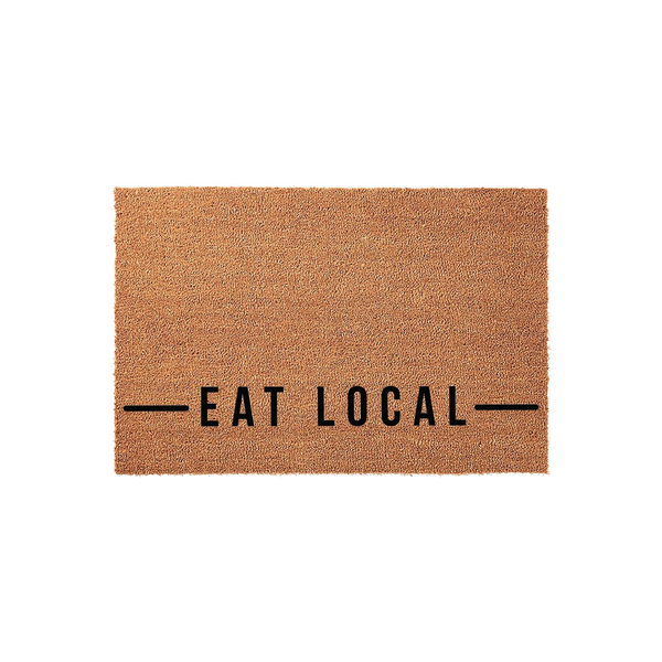 Eat Local coir doormat featuring a natural brown fiber texture and bold black text centered on the front, providing a rustic and welcoming farmhouse aesthetic for your front porch entrance or home entryway decor.