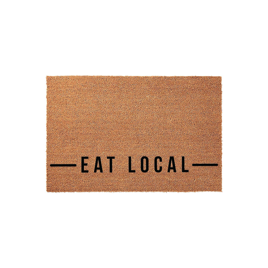 Eat Local coir doormat featuring a natural brown fiber texture and bold black text centered on the front, providing a rustic and welcoming farmhouse aesthetic for your front porch entrance or home entryway decor.