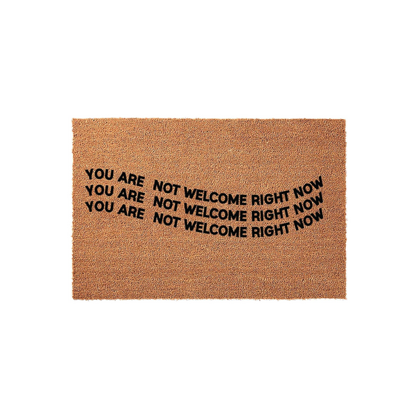 Funny Coir Doormat with the text You Are Not Welcome Right Now printed in bold black letters across the center, featuring a natural brown fiber texture that provides a humorous and sarcastic greeting for your front porch or