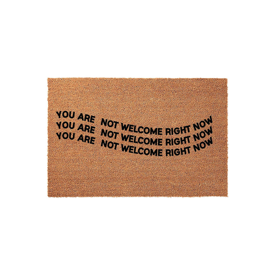 Funny Coir Doormat with the text You Are Not Welcome Right Now printed in bold black letters across the center, featuring a natural brown fiber texture that provides a humorous and sarcastic greeting for your front porch or