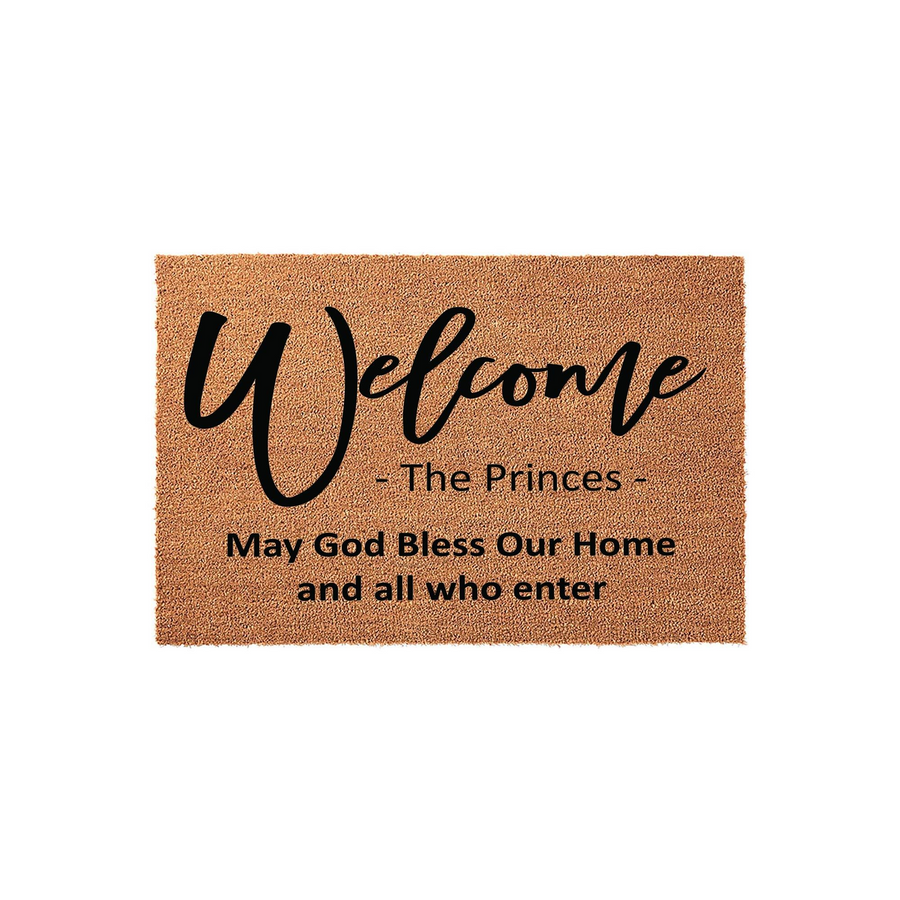 Personalized coir welcome doormat featuring the word Welcome in elegant script, a custom family name, and the religious phrase May God Bless Our Home and all who enter printed in black ink on a natural brown textured fiber
