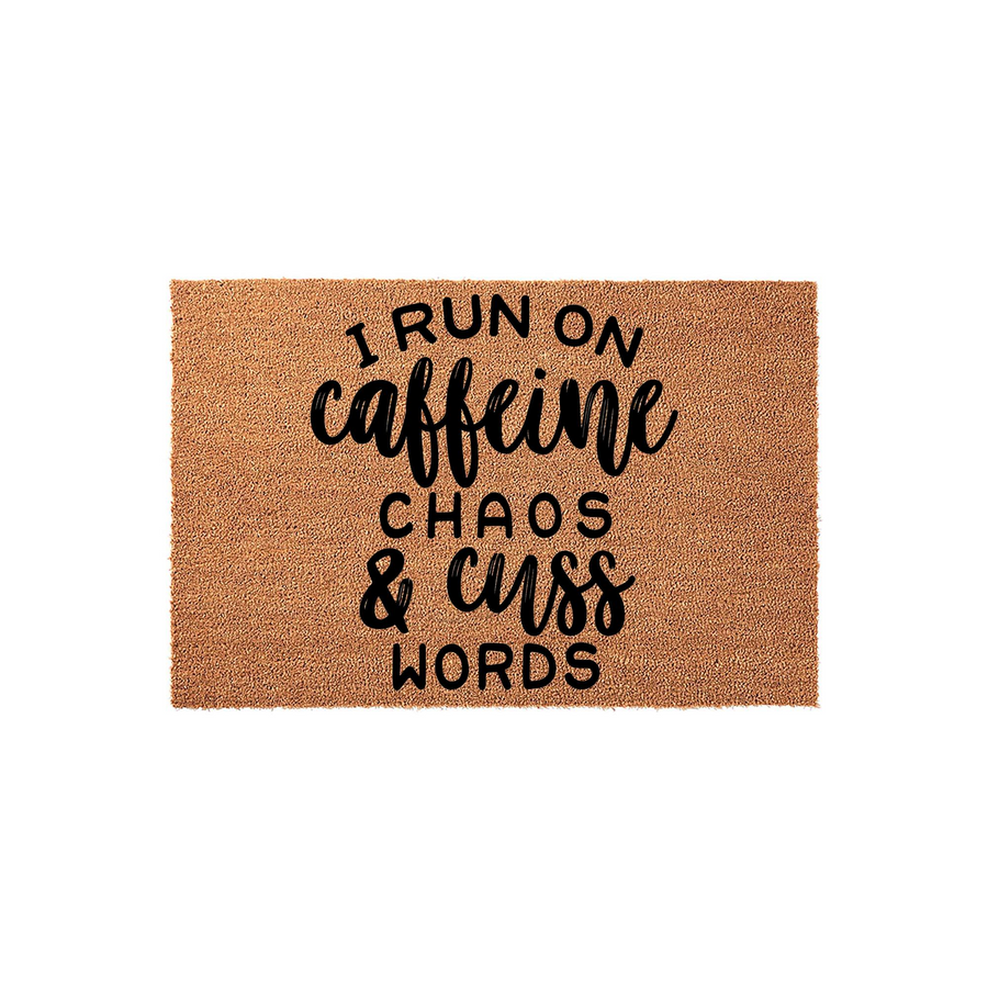 Funny Caffeine Chaos and Cuss Words doormat featuring bold black typography printed on a natural brown coir fiber mat, creating a humorous and welcoming entrance piece for any home or apartment front porch entryway.