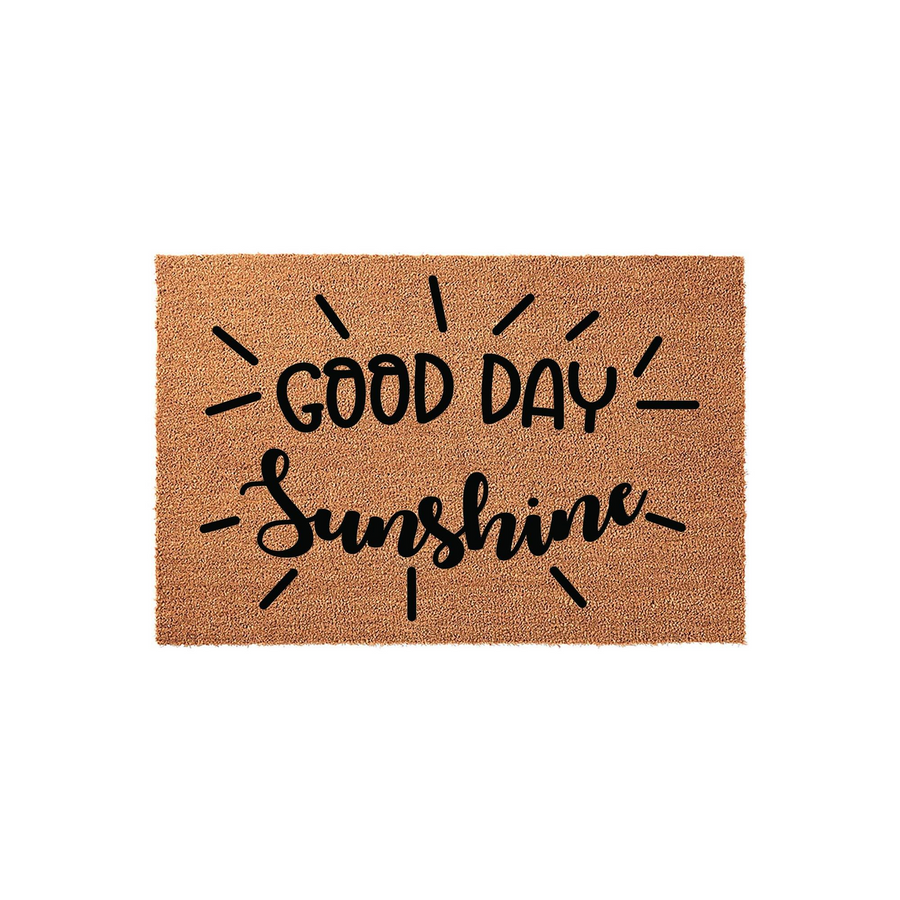 Good Day Sunshine coir doormat featuring a natural brown fiber texture with black printed text and sunburst rays, creating a cheerful and welcoming entryway decor piece for your front porch or home entrance on a plain white