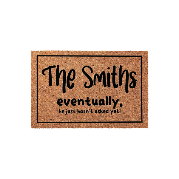 Personalized coir doormat featuring a humorous custom family name design that reads The Smiths eventually, he just hasn't asked yet, set against a plain white background to highlight the natural brown texture of the durable