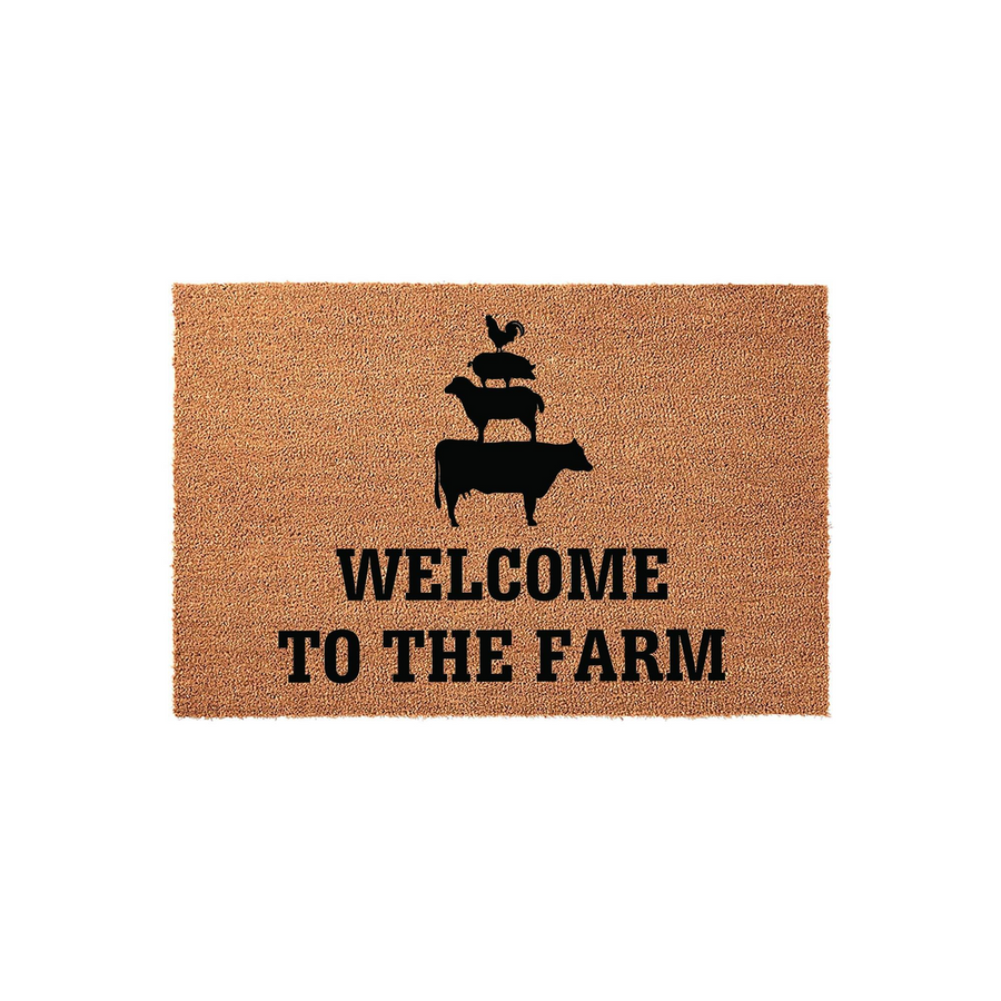 Farmhouse Welcome To The Farm coir doormat featuring a black silhouette of a cow, sheep, pig, and rooster stacked on top of each other, set against a natural brown textured fiber background for a rustic outdoor entryway decor