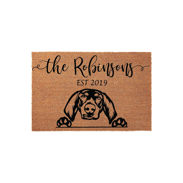 Personalized Dog Breed Coir Doormat featuring a custom family name and established year, showcasing a detailed black silhouette of a hound dog peeking over the edge with its paws resting on the natural brown textured fiber
