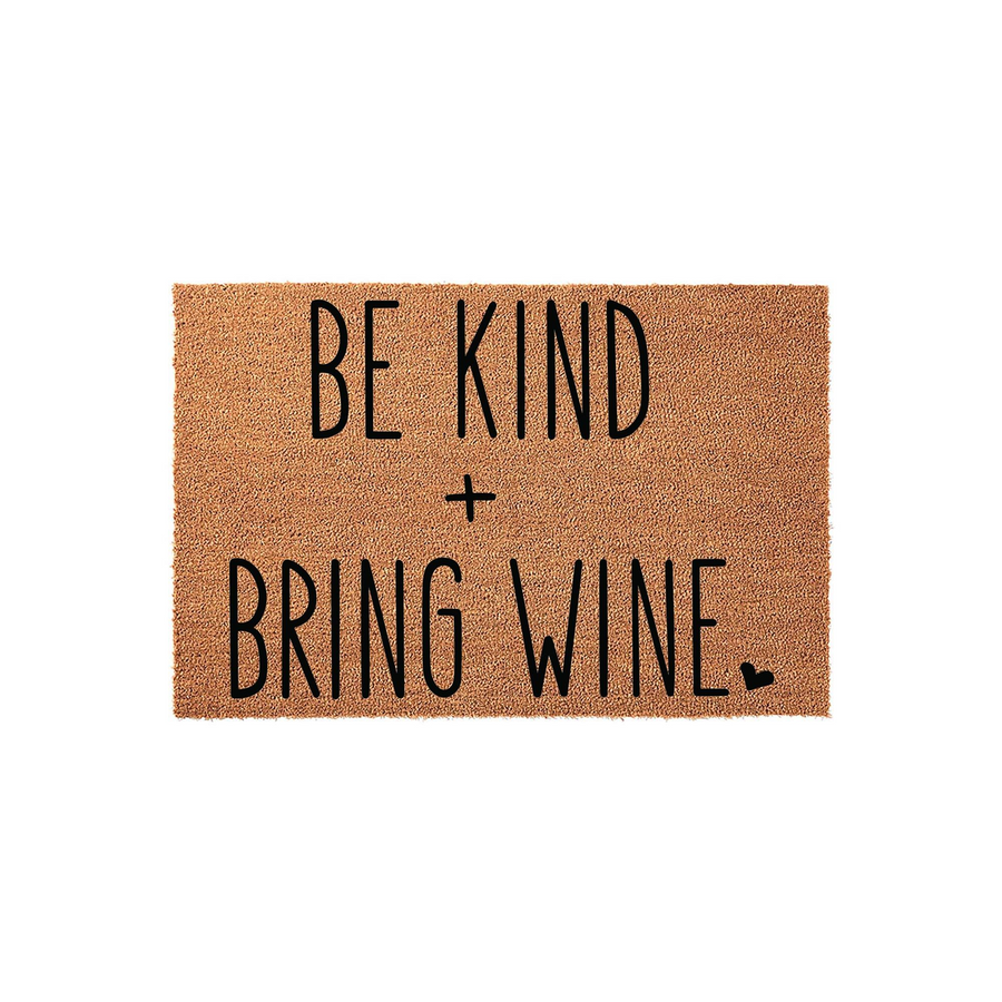 Be Kind and Bring Wine coir doormat featuring bold black lettering on a natural brown fiber background, creating a humorous and welcoming entrance piece for any home front porch or entryway that adds a touch of personality to
