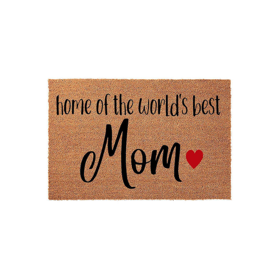 World's Best Mom coir doormat featuring a natural brown fiber texture with black script lettering that reads home of the world's best Mom, accented by a small red heart icon on a clean white studio background for a front porch