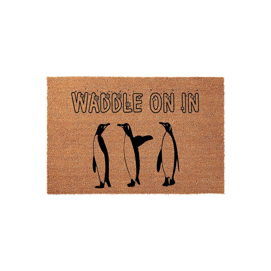 Waddle On In penguin coir doormat featuring a natural brown fiber texture with three black silhouette penguins printed in the center, creating a fun and welcoming entrance decor piece for any animal lover's home front porch.
