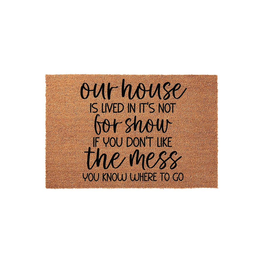 Funny Our House Is Lived In Not For Show Doormat featuring a natural coir texture with bold black typography that reads a humorous message about a messy home, presented on a clean white background for a modern farmhouse entryway