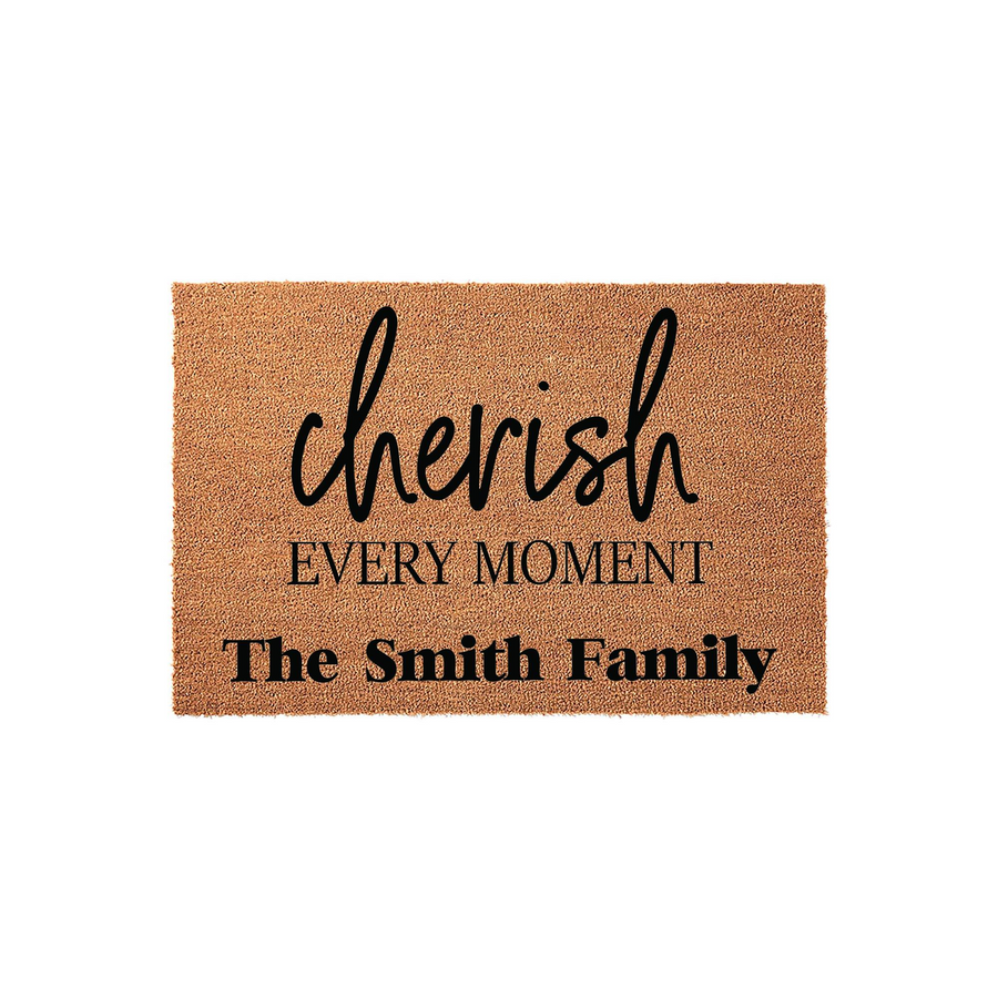 Personalized family name doormat featuring the phrase cherish every moment in elegant black script and bold lettering on a natural coir fiber background, creating a welcoming entryway decor piece for any home entrance.