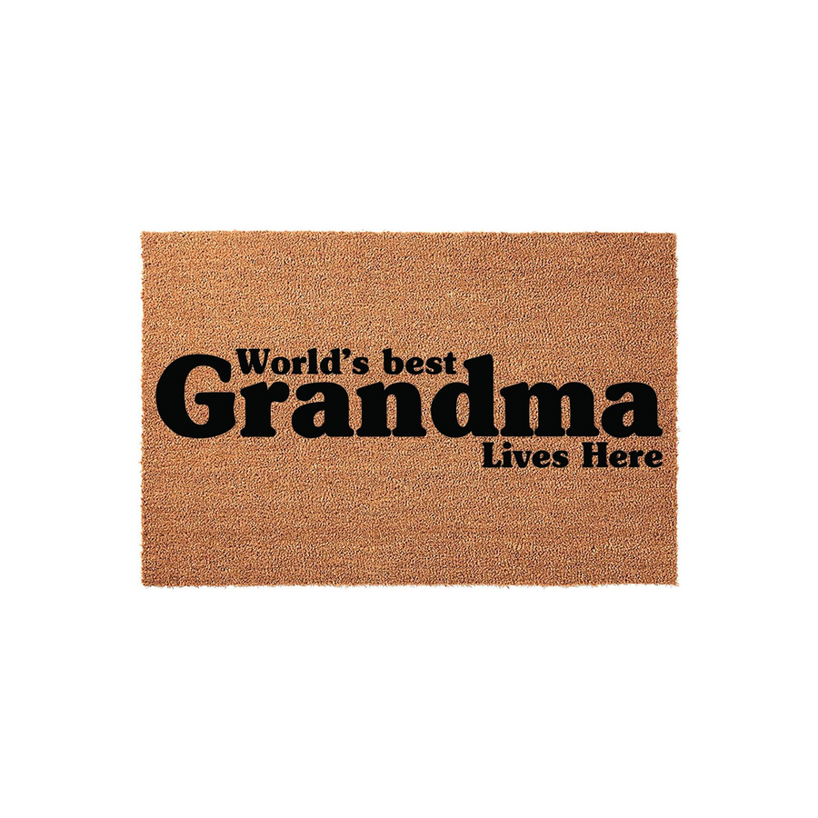 World's Best Grandma Coir Doormat featuring bold black text printed on a natural brown fiber mat, creating a welcoming entryway decor piece that celebrates a beloved grandmother and her home in a simple, rustic style.