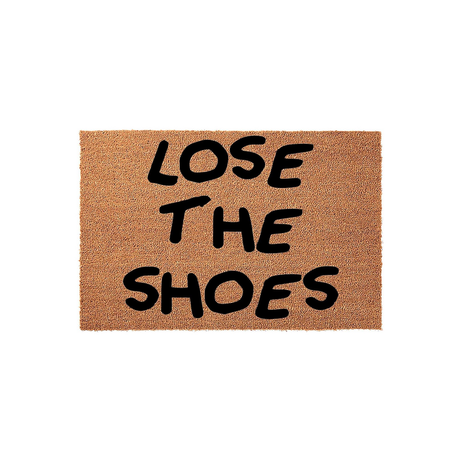 Lose The Shoes coir doormat featuring a natural brown fiber texture and bold black lettering that creates a humorous and functional entryway accent for any home, displayed against a clean white studio background.