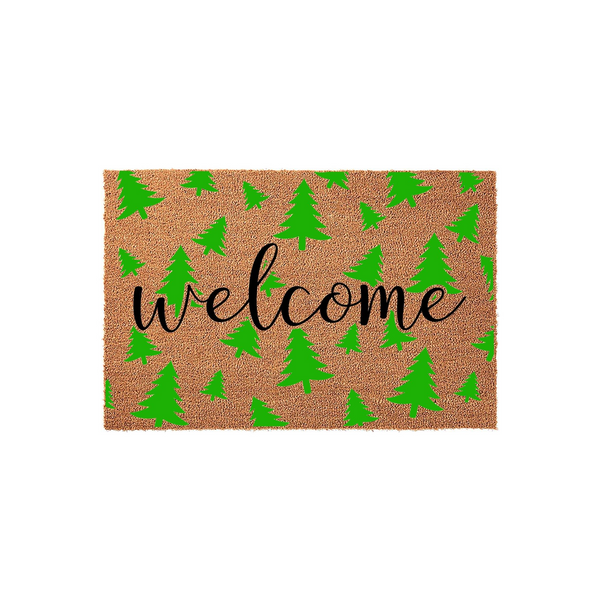 Christmas Tree Welcome Doormat featuring a natural coir fiber texture with a repeating pattern of bright green pine trees and the word welcome written in a stylish black cursive script across the center of this festive holiday