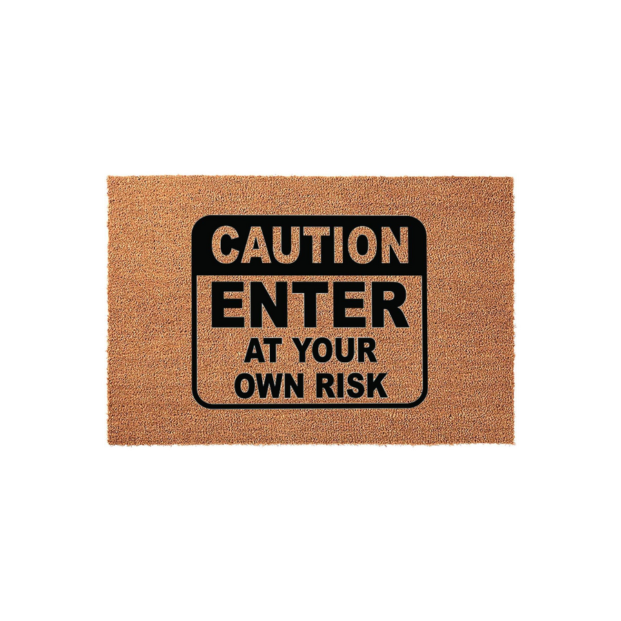 Caution Enter At Your Own Risk doormat featuring a textured brown coir surface and a bold black sign graphic in the center, providing a humorous and warning-style welcome for guests at your front door or home entryway.