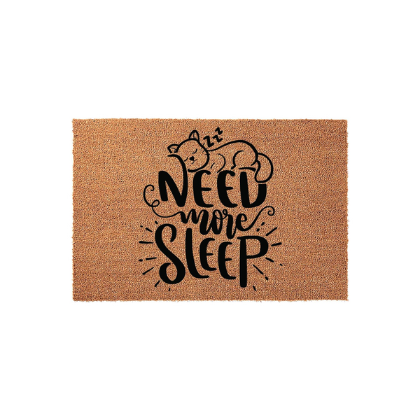 Need More Sleep cat doormat featuring a cute sleeping kitten illustration with zzz symbols, printed in bold black lettering on a natural brown coir fiber mat, perfect for a cozy entryway or a funny home decor accent for cat