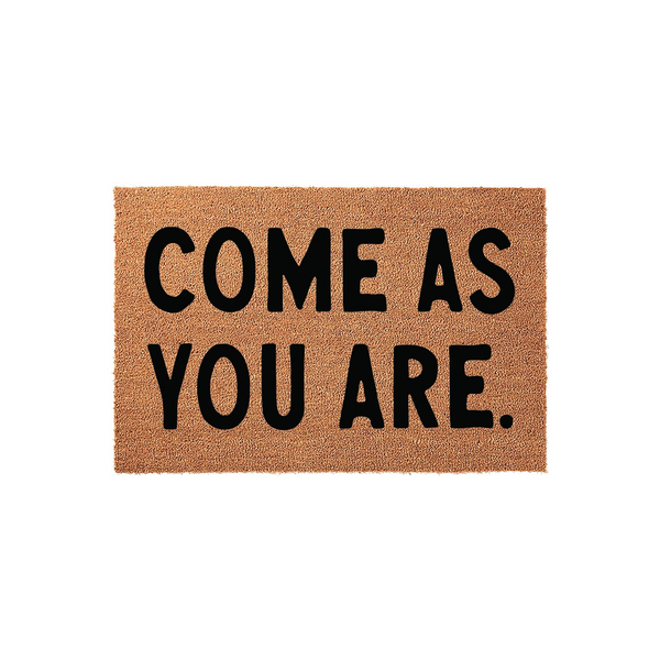Come As You Are coir doormat featuring bold black lettering on a natural brown fiber background, designed to provide a welcoming and rustic touch to your front porch entryway while keeping your home clean from dirt and debris.