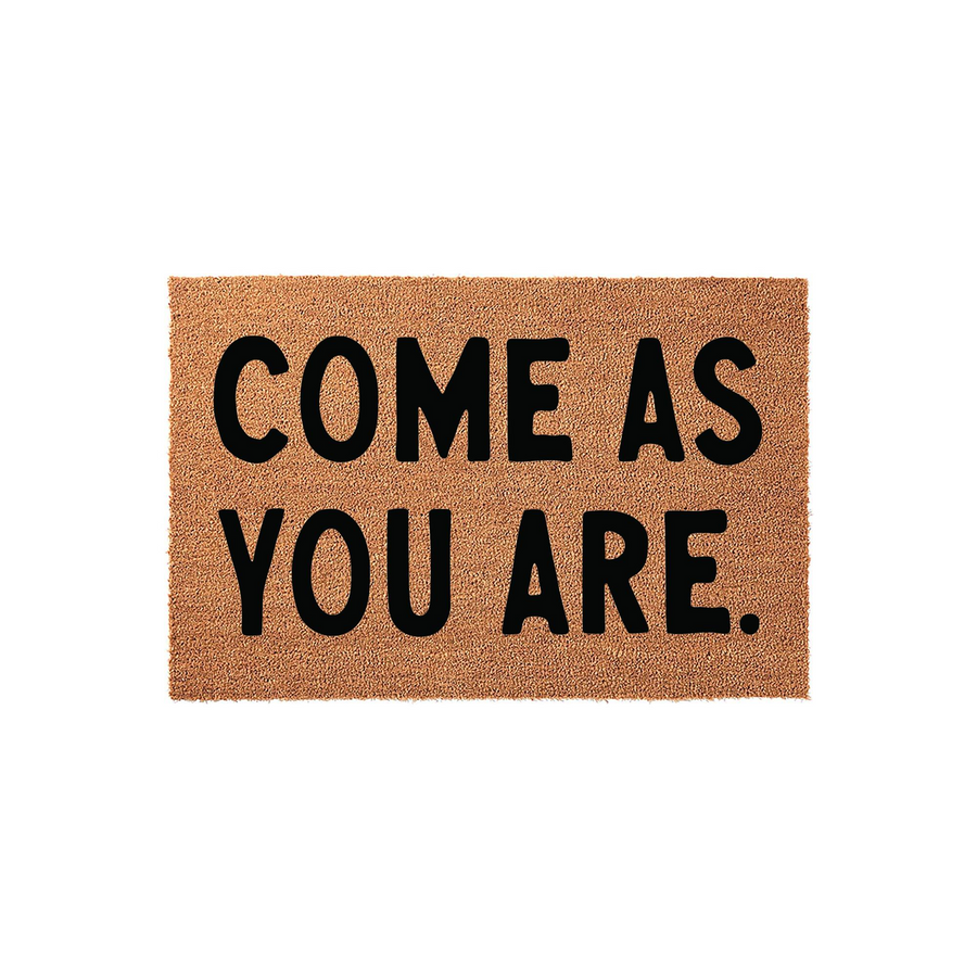 Come As You Are coir doormat featuring bold black lettering on a natural brown fiber background, designed to provide a welcoming and rustic touch to your front porch entryway while keeping your home clean from dirt and debris.