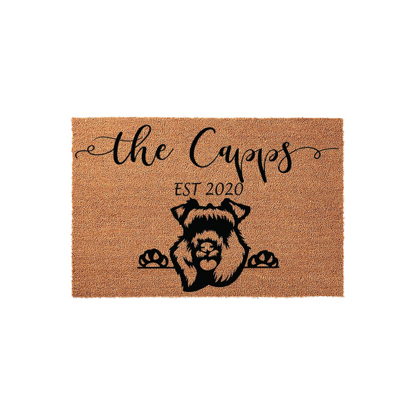 Personalized Schnauzer dog doormat featuring a cute black silhouette of a Schnauzer peeking over the edge with its paws, customized with a family name and established year on a natural tan coir fiber background for a welcoming