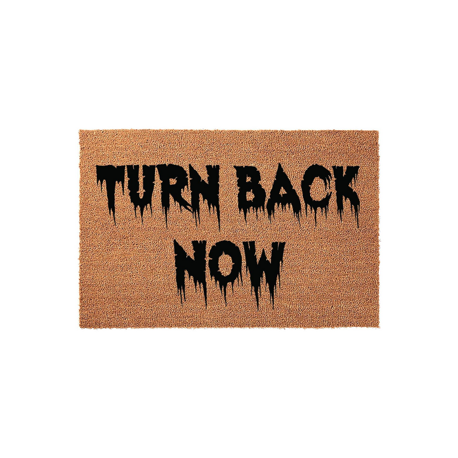 Turn Back Now Halloween Doormat featuring a natural coir fiber texture with bold, black, dripping horror-style lettering that creates a spooky entryway accent for your front porch during the fall season and October holiday
