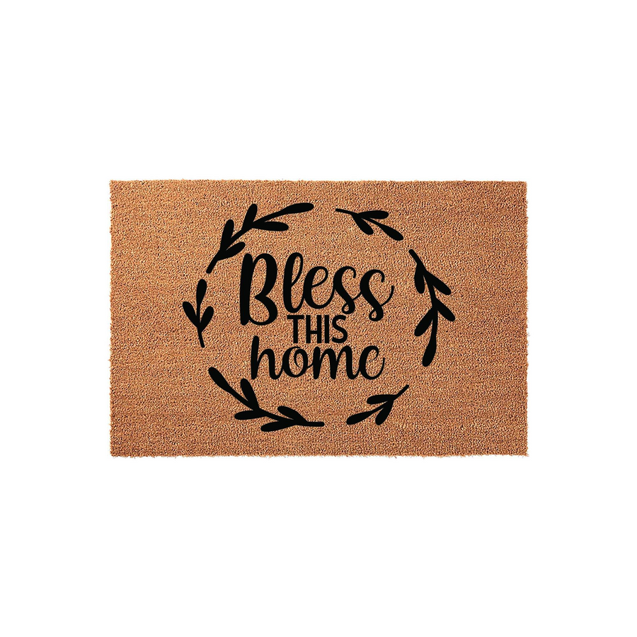 Bless This Home coir doormat featuring a natural tan fiber texture and a black printed design of a leafy wreath surrounding the inspirational text, creating a welcoming farmhouse style entrance for any front porch or entryway.