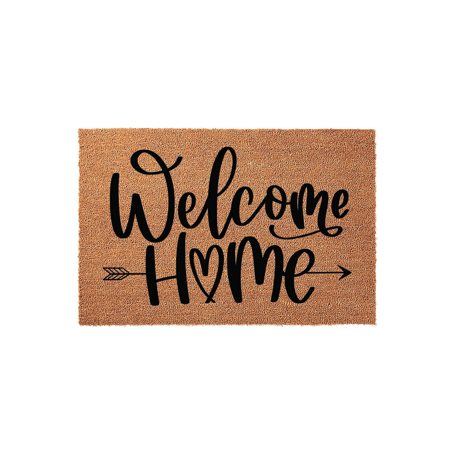 Welcome Home coir doormat featuring black script lettering and a decorative arrow design with a heart detail, set against a plain white background for a clean look that adds a warm touch to any front porch or entryway decor.
