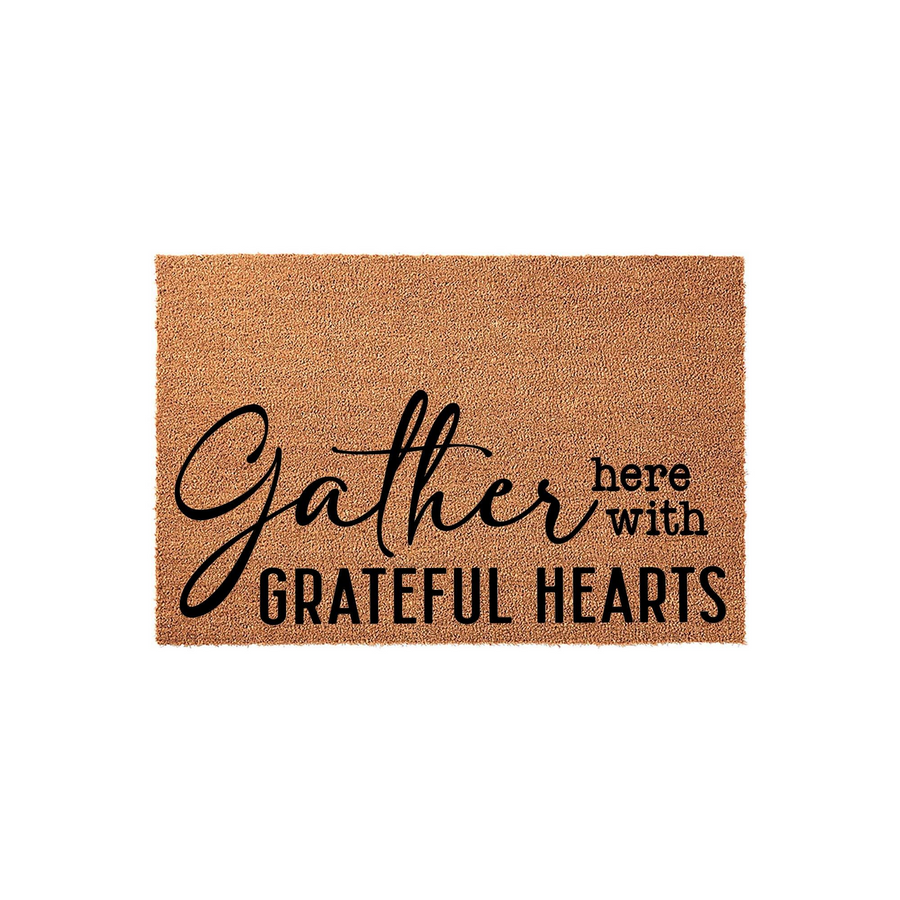 Gather Here With Grateful Hearts coir doormat featuring a natural tan fiber texture and bold black typography, making it a welcoming addition to any front porch or entryway decor for the fall season or year-round home styling.