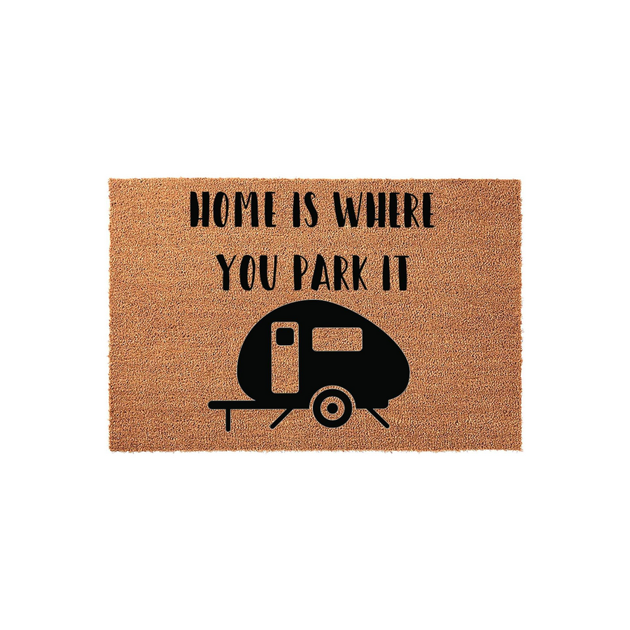 Home Is Where You Park It camper doormat featuring a natural coir texture and a bold black graphic of a travel trailer, making it a fun outdoor welcome mat for camping enthusiasts and RV owners who love their mobile lifestyle.