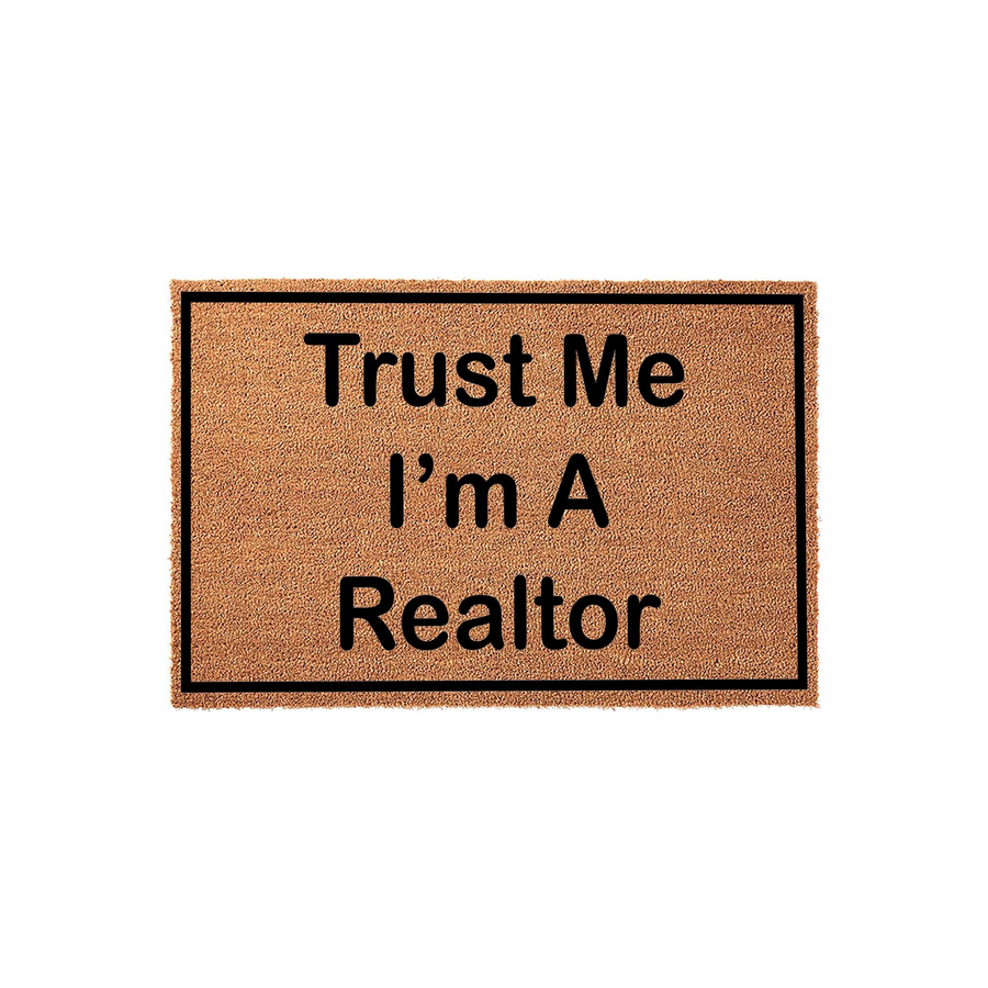 Trust Me I'm A Realtor doormat featuring a natural coir fiber texture and a bold black border, displaying the humorous text in a clean sans-serif font against the tan background for a professional yet fun entryway home decor
