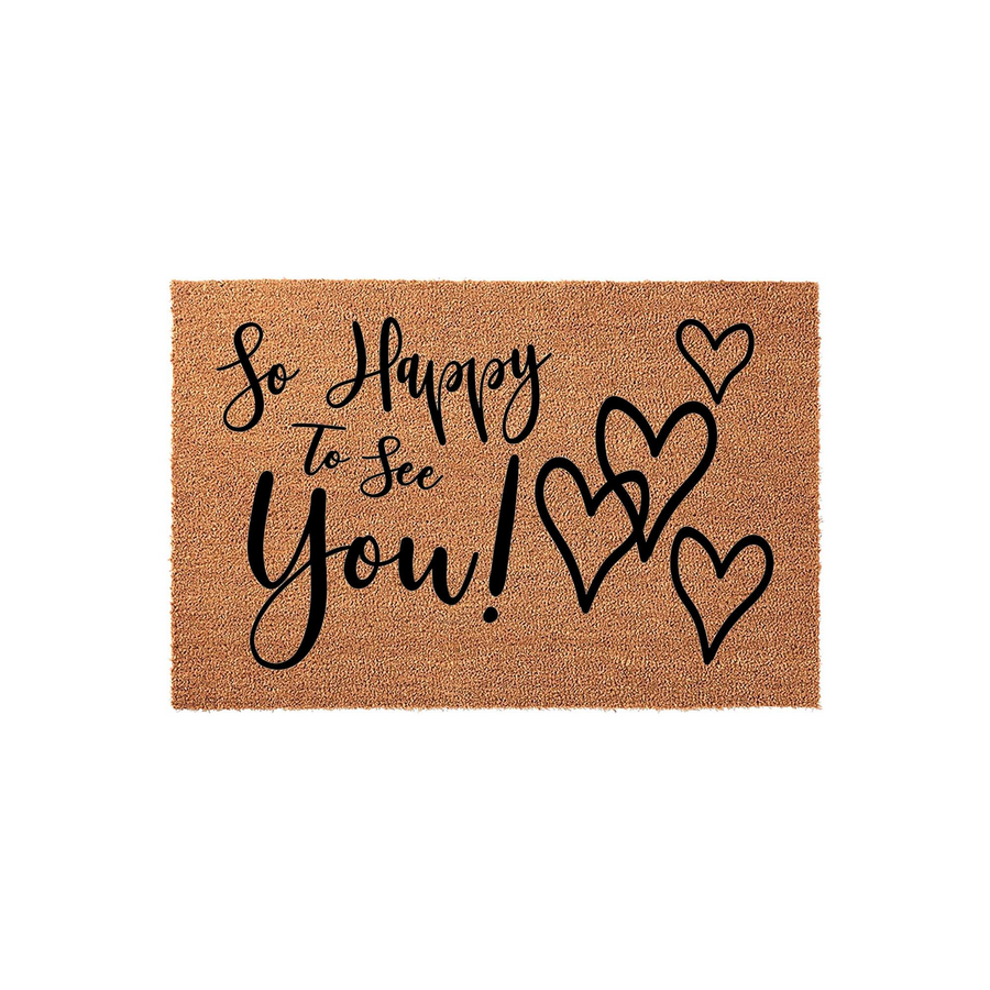 So Happy To See You Coir Doormat featuring a natural tan fiber texture with black script lettering and three hand-drawn heart outlines, creating a warm and inviting entryway decor piece for your front porch or home entrance.
