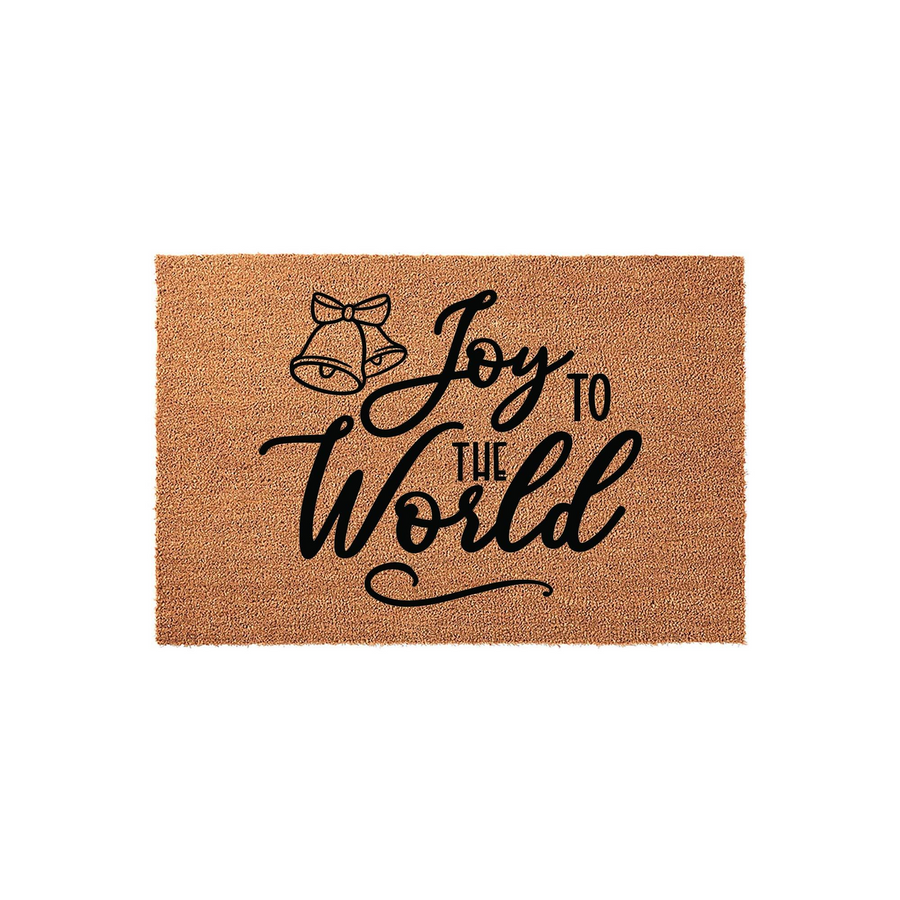 Joy to the World Christmas doormat made of natural coir fiber, featuring a festive black printed design of two bells and elegant calligraphy text centered on a rectangular mat against a clean white studio background.