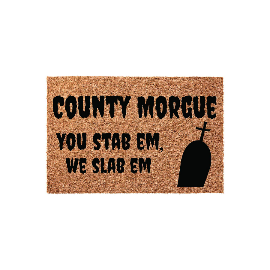 County Morgue Halloween Doormat featuring a spooky tombstone graphic and the humorous text You Stab Em We Slab Em printed in black on a natural coir fiber mat, perfect for a scary front porch entryway during the fall holiday
