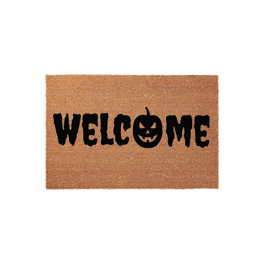 Halloween Welcome Doormat featuring a spooky black jack-o-lantern pumpkin replacing the letter O in the word Welcome, printed on a natural tan coir fiber mat that adds a festive touch to your front porch decor for the autumn